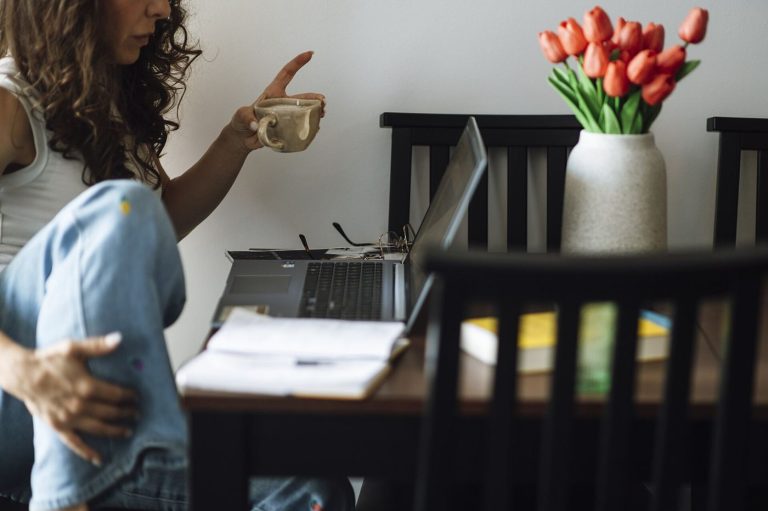 Hybrid Schedules Bring Flexibility and New Stress Pressures person working on laptop in home office