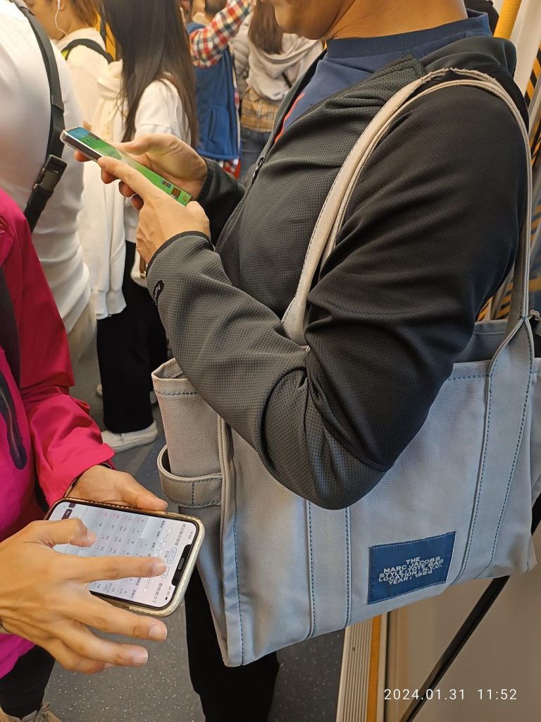 Budget Smartphones Get Flagship Cameras: The Big Shift of 2026 People checking their smartphones while out and about